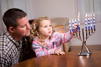 Jewish father and daughter celebrating Chanukah